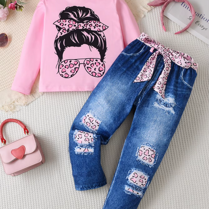 Pink sweatshirt with graphic design and blue jeans with floral details on a light background

