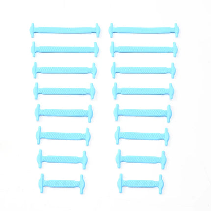 Multiple blue plastic needles arranged in rows on a white background

