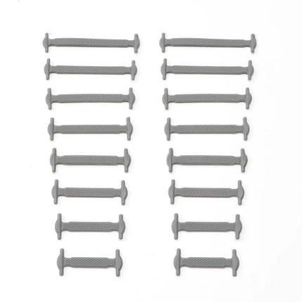 Multiple gray cylindrical objects arranged in rows on a white background

