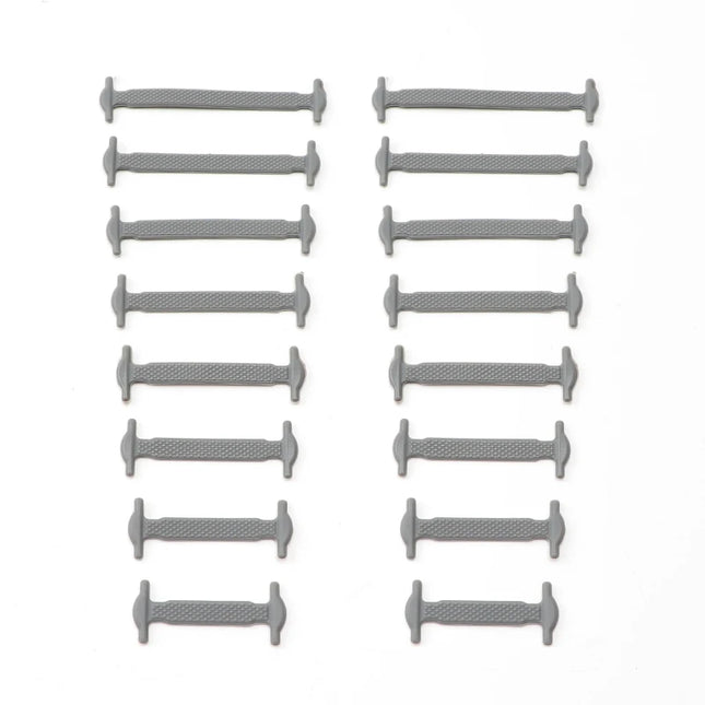 Multiple gray cylindrical objects arranged in rows on a white background

