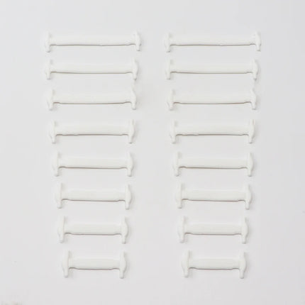 Set of white pillows stacked on a light gray background

