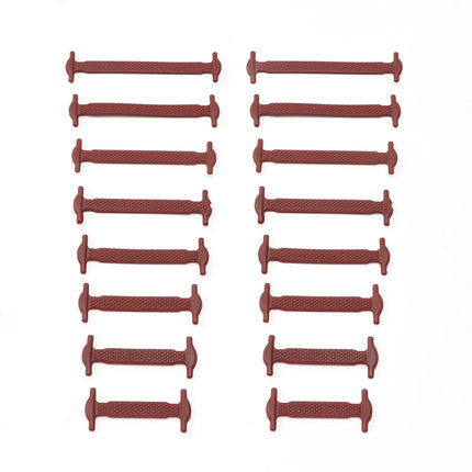 Set of red plastic dowels arranged in a grid on a white background

