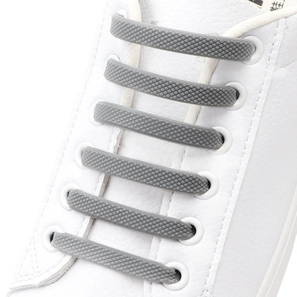 Gray shoelaces on a white sneaker


