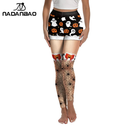Halloween-themed leggings with ghost, pumpkin, and spider web designs on a white background.

