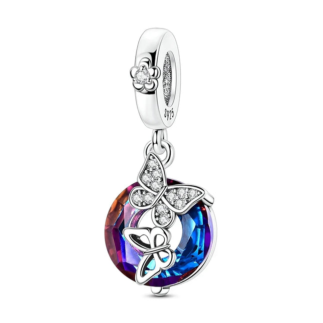 Silver charm with a colorful gemstone and butterfly design on a white background

