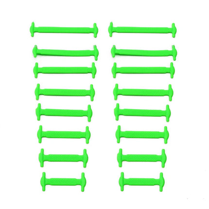 Multiple green plastic buttons arranged in two vertical rows on a white background

