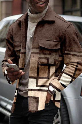Person wearing a patterned jacket holding a phone outdoors.

